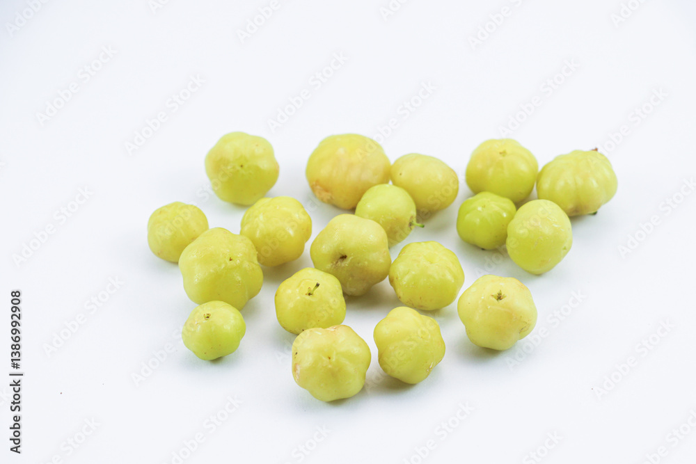 Scattered Phyllanthus acidus fruits on white Scattered Phyllanthus acidus fruits on white
