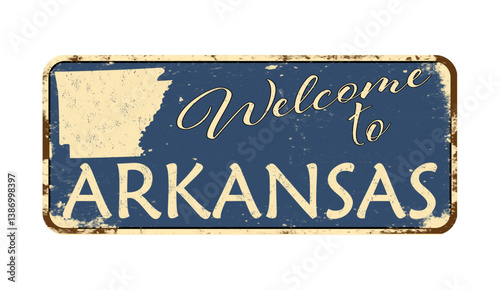 Welcome to Arkansas. A worn blue plaque with the name and outline of the state. Welcome inscription on the road sign