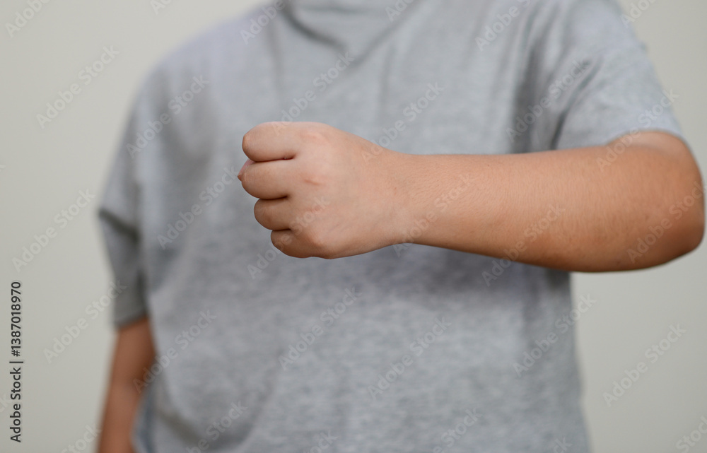 The child's hand is clenched into a fist.