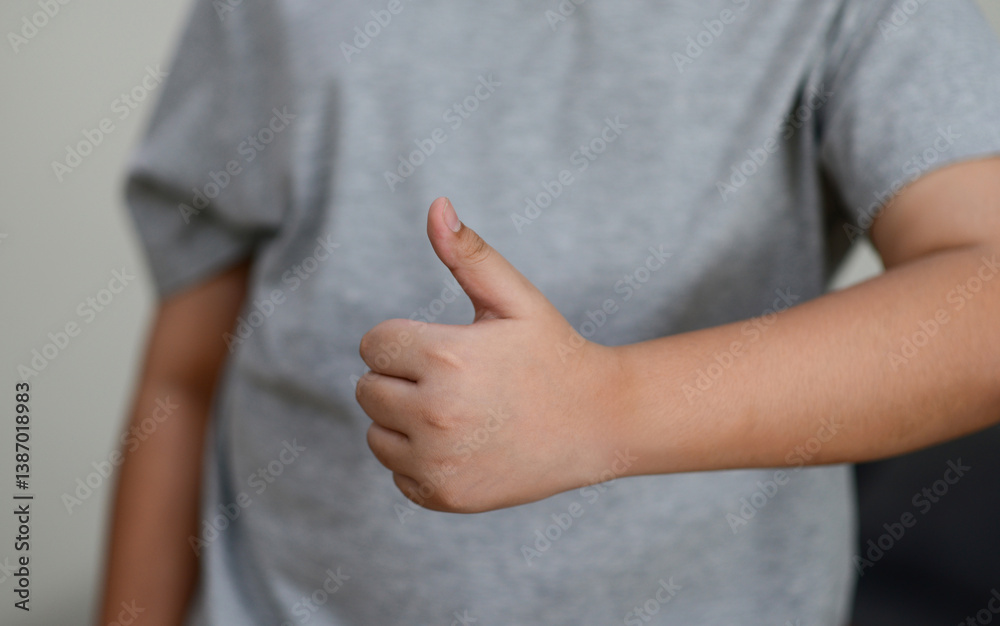 Child's hand thumb up is a symbol