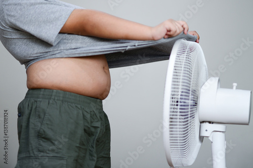 Obraz na płótnie Fan hot weather and children Hot child standing in front of a fan fat child w salonie