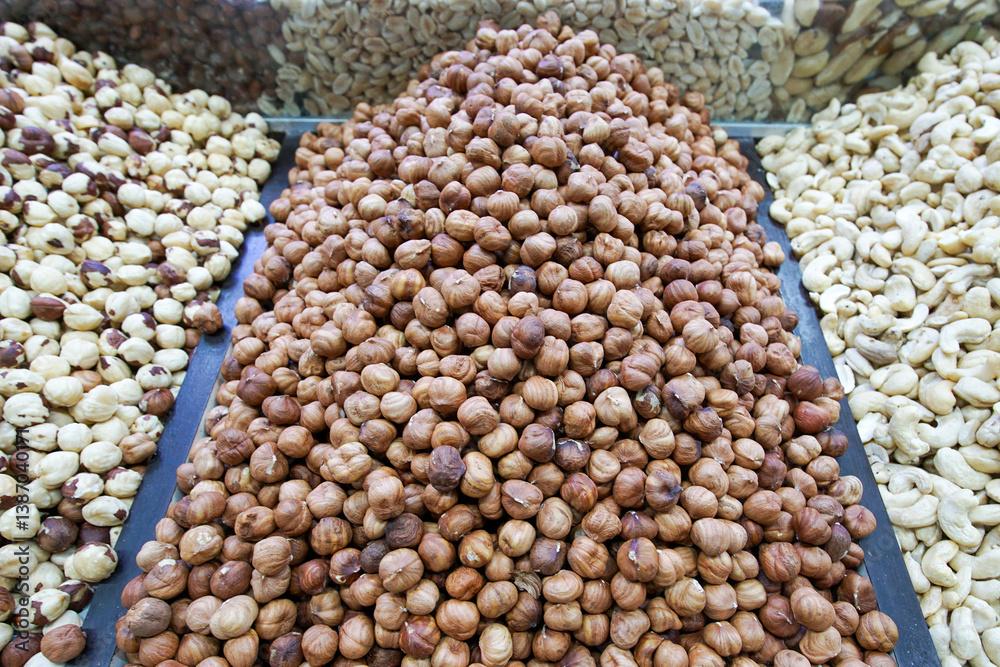 Peeled hazelnuts are lying on the market for sale. Hazelnut kernels close-up. Peeled hazelnuts are lying on the market for sale. Hazelnut kernels close-up.