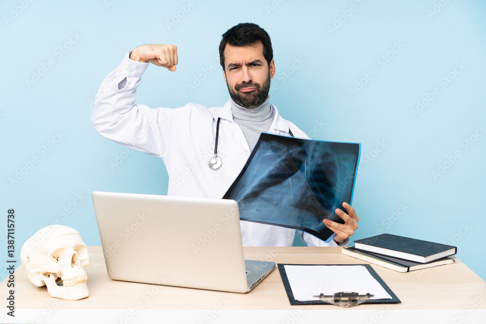 Professional traumatologist in workplace doing strong gesture Professional traumatologist in workplace doing strong gesture