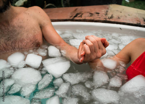 Foto Man and woman take an ice bath outdoors in a tropical setting