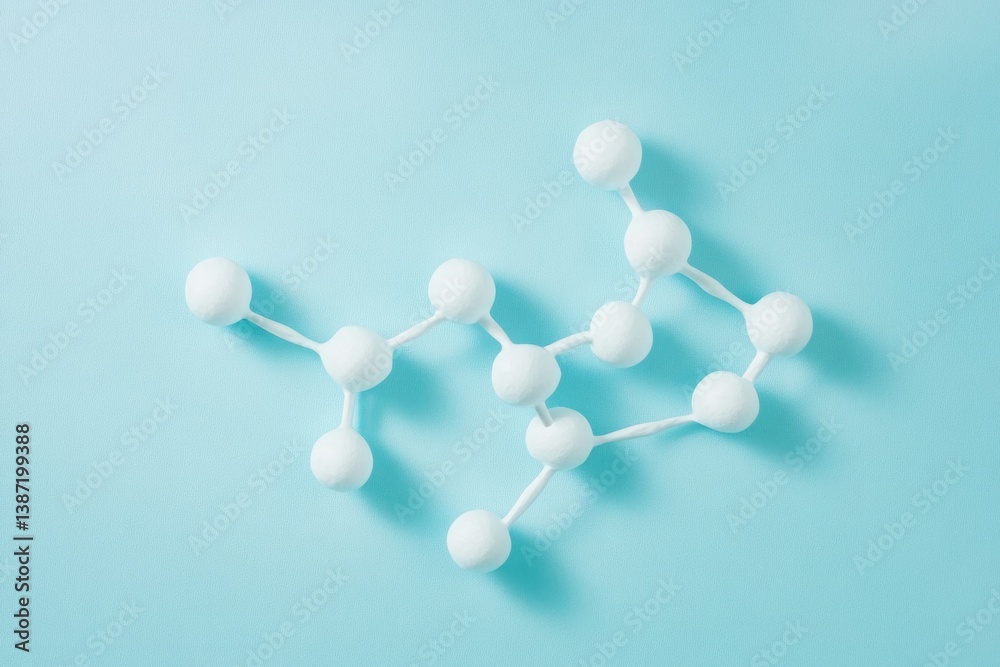 Obraz premium A molecular structure model, representing atoms and bonds in a complex molecule. It's displayed on a light blue background.