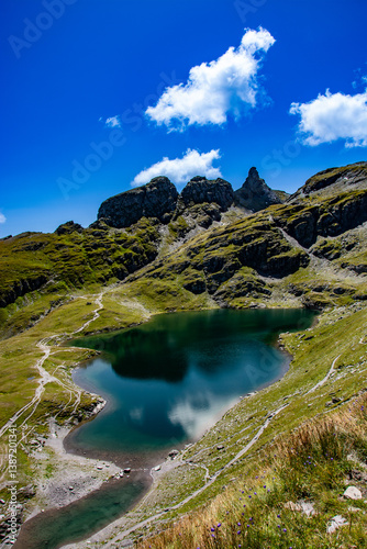 Schwarzsee on the Pizol,  canton of St. Gallen at an altitude of 2372m photographed on the 5 lakes hike. The turquoise colour and the impressive mountains reflected in the lake are simply breathtaking