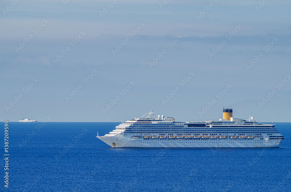 Mega family cruiseship cruise ship liner Pacifica anchored offshore of Civitavecchia Rome, Italy before reactived after Covid pandemic with other vessels in port and coastline