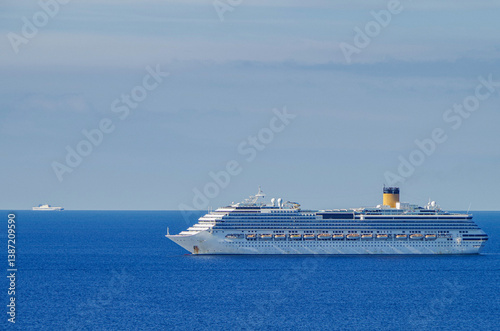 Obraz na płótnie Mega family cruiseship cruise ship liner Pacifica anchored offshore of Civitavecchia Rome, Italy before reactived after Covid pandemic with other vessels in port and coastline w salonie