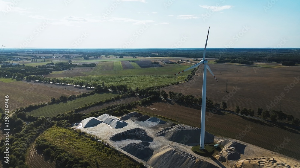 Windmill in aerial view of farmland landscape