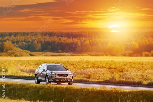 Sunset drive in a stylish SUV through rural landscape