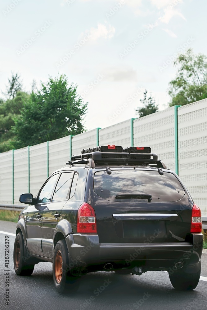 SUV traveling on highway with roof gear