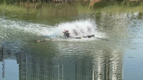 Water Aerator in a Pond Reflecting Buildings