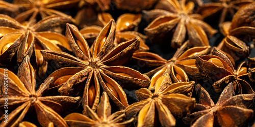 Obraz na płótnie Anise stars texture background, above view close up flavor spices dried anise seeds on dark, banner with natural condiments, aromatic ingredient for cooking drink and food w salonie