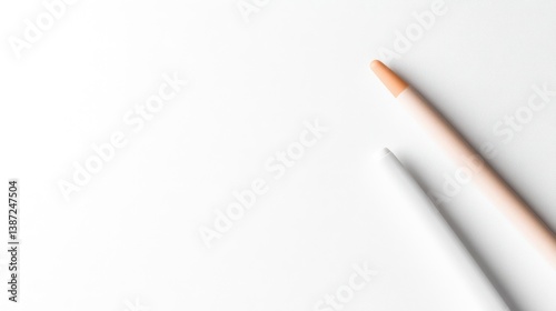 Two pencils lying on a white surface, one sharpened and one unsharpened, minimalist composition with soft lighting, and concept of simplicity and creativity.