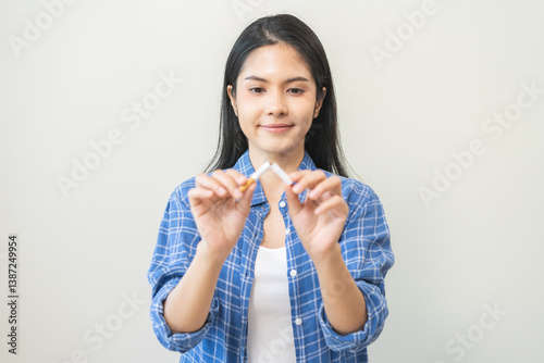 Quit, stop smoking, addiction asian young woman, girl refusing cigarette, smoker quitting smoke, hand in broken, break tobacco. Quit bad habit, health care concept. Willpower lifestyle of people. photo