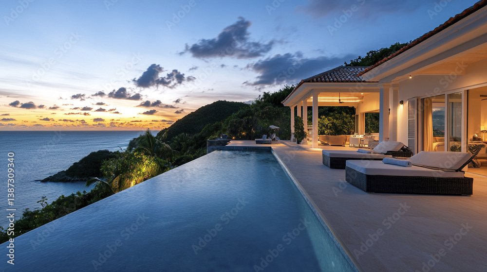 Fototapeta premium Luxurious beachfront villa with infinity pool at sunset, offering stunning ocean views