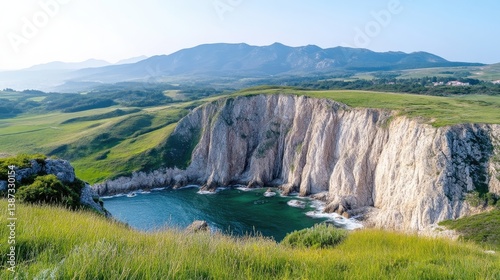 Dramatic coastal scenery with cliffs, bay, and lush green hills