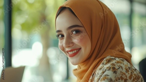 Obraz na płótnie A cheerful young woman wearing a modern, fashionable outfit with a hijab, smiling brightly and enjoying the city's atmosphere. w salonie