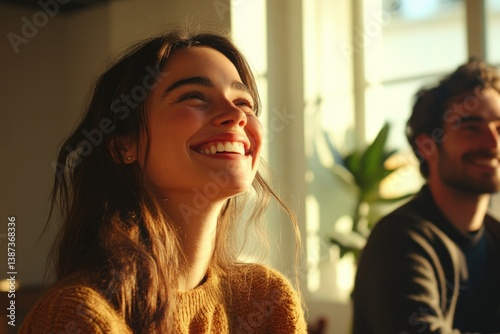 Smiling man and woman laughing at joke.