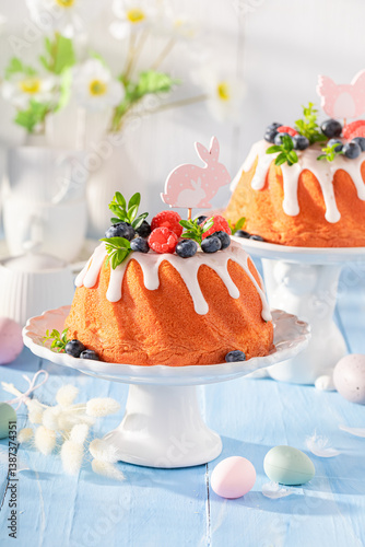 Glazed ring cake for Easter with lemon icing and fruit.