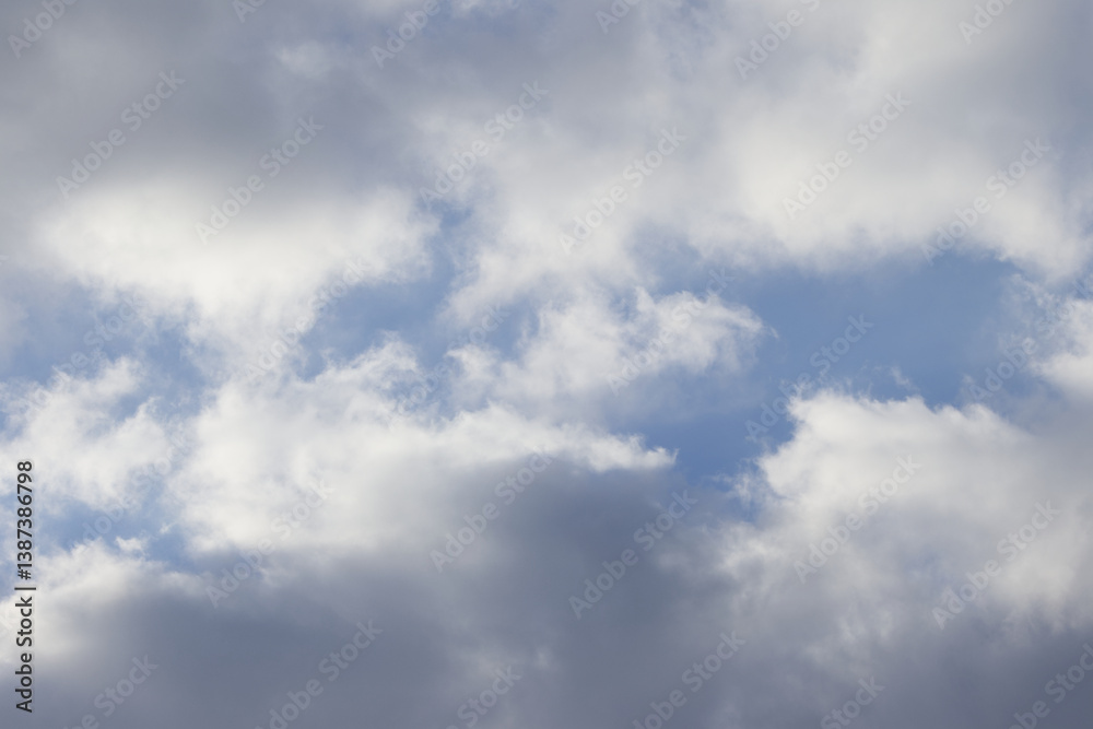 big puffy clouds passing by, large gray clouds, a few blue patches of sky are visible, grey passing clouds and a few blue spots, white fluff in the sky, grey haze accumulation with blue background big puffy clouds passing by, large gray clouds, a few blue patches of sky are visible, grey passing clouds and a few blue spots, white fluff in the sky, grey haze accumulation with blue background