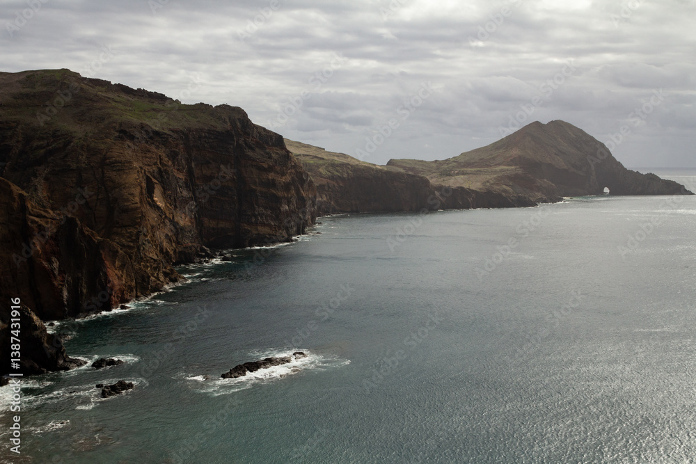 A dramatic view of the Vereda da Ponta de São Lourenço trail in Madeira, with the deep blue ocean below. A dramatic view of the Vereda da Ponta de São Lourenço trail in Madeira, with the deep blue ocean below.