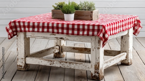A rustic white table adorned with a vibrant red and white checkered tablecloth, featuring potted herbs, perfect for a charming dining setting and home interior decor.