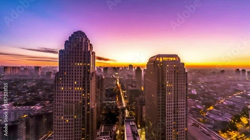 Time-lapse of a city awakening at sunrise, with golden light illuminating skyscrapers and streets, revealing the vibrant rhythm and morning energy of urban life