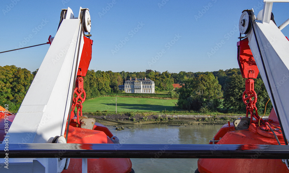 Small classic cruiseship cruise ship liner on Seine River near Rouen, France with chateau and castles and pictures coastal landscape scenery