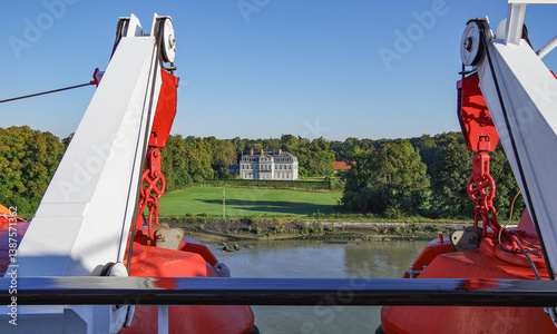 Obraz na płótnie Small classic cruiseship cruise ship liner on Seine River near Rouen, France with chateau and castles and pictures coastal landscape scenery w salonie