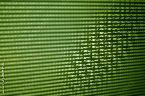 Close-up of a digital display featuring a matrix of green binary code, highlighting the technology behind data processing and computing.