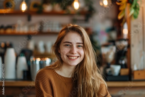 Portrait of a smiling young Caucasian woman in a coffee shop