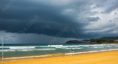 Surfer Entering Ocean Waves Under Dark Overcast Sky Before Storm