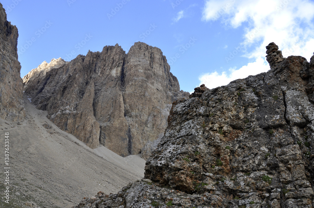 Fototapeta premium A ravine or valley formed between two large rocks in the Gray Mountains is covered with snow. The snowy valley between the mountains is used as a road