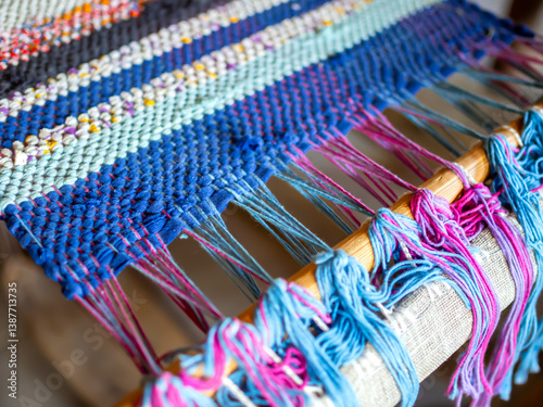 Fragment of a homespun rug on a hand loom frame. (Shallow depth of field)