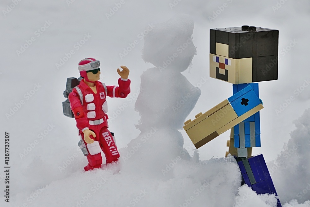 Obraz premium LEGO Minecraft figure of Steve and GI JOE medic Lifeline, version from year 1986 building a snowman together.