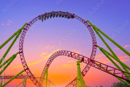 Картината върху платно Thrilling roller coaster racing through twists and loops at lively amusement par
