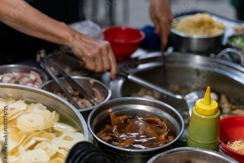 This savory dish features braised tofu and braised eggs, simmered in a rich soy-based sauce until fully infused with deep, umami flavors. The tofu is tender yet firm, absorbing the fragrant braising