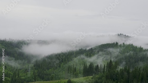 Mountains rise above the clouds of thick fog. Footage from a bird's eye view. Location place Carpathian mountains, Ukraine, Europe. Time lapse clip. Filmed in UHD 4k video. Beauty of earth.