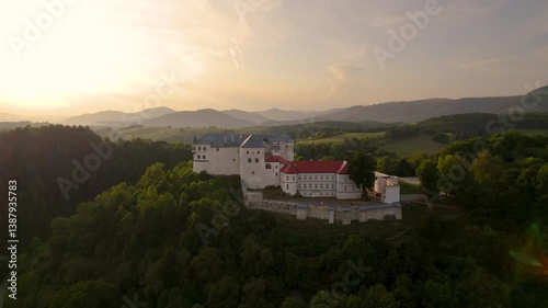 Monumental medieval castle at sunset, beautiful breathtaking drone shot. Lupčiansky hrad, Slovakia. 