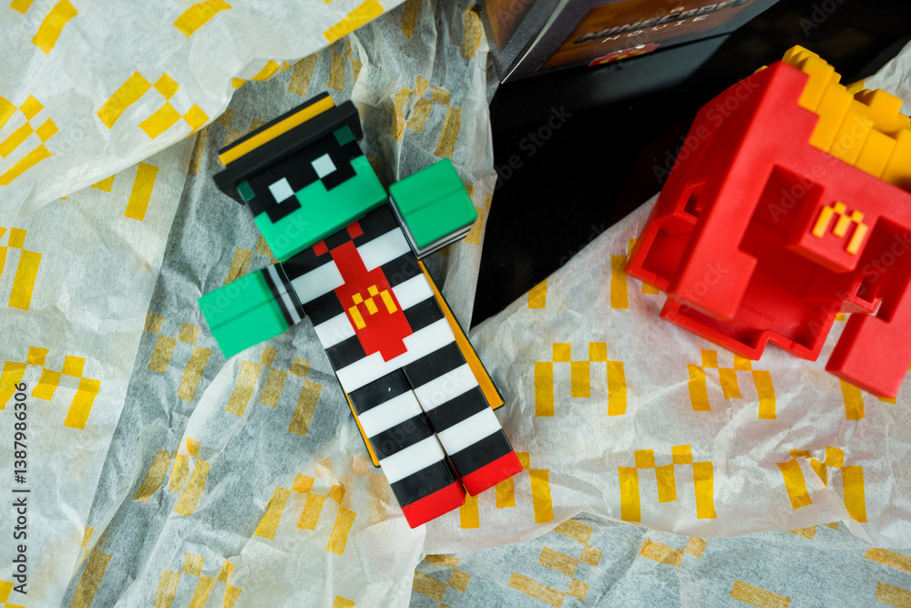 Naklejka premium Bangkok, Thailand - April 6, 2025 : Zombie hamburglar and Minecraft fries helmet, Minecraft blind box from McDonald's collaborates,