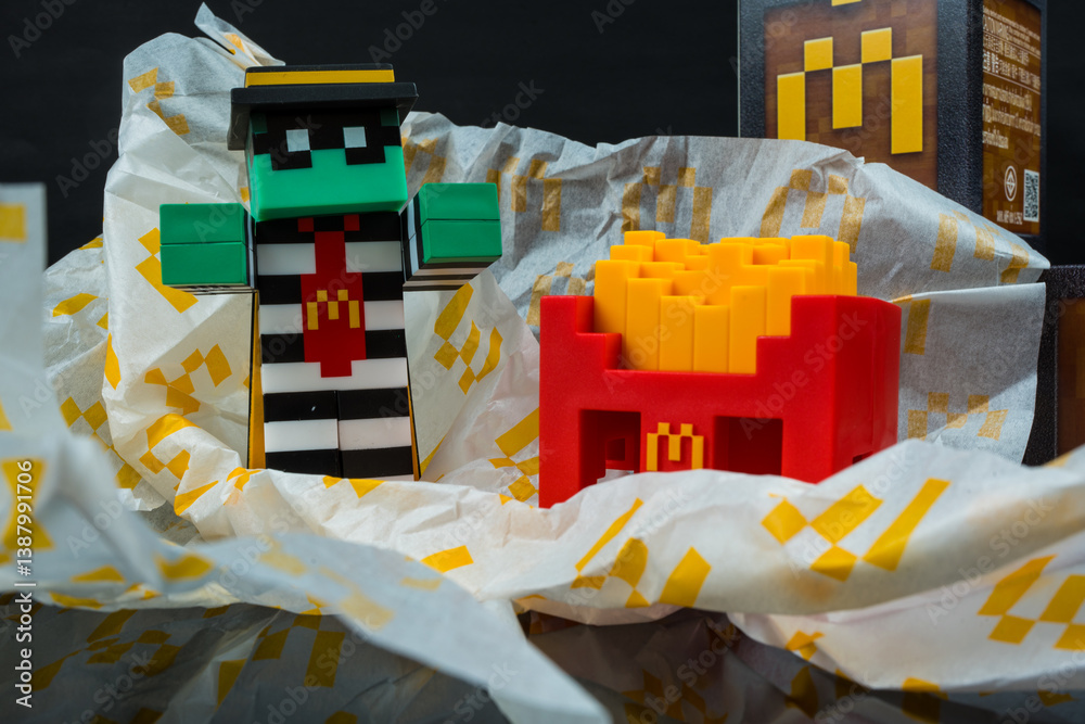 Fototapeta premium Bangkok, Thailand - April 6, 2025 : Zombie hamburglar and Minecraft fries helmet, Minecraft blind box from McDonald's collaborates.