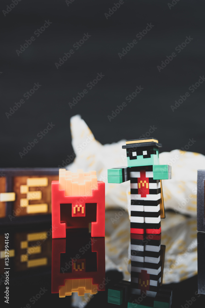 Fototapeta premium Bangkok, Thailand - April 6, 2025 : Zombie hamburglar and Minecraft fries helmet, Minecraft blind box from McDonald's collaborates