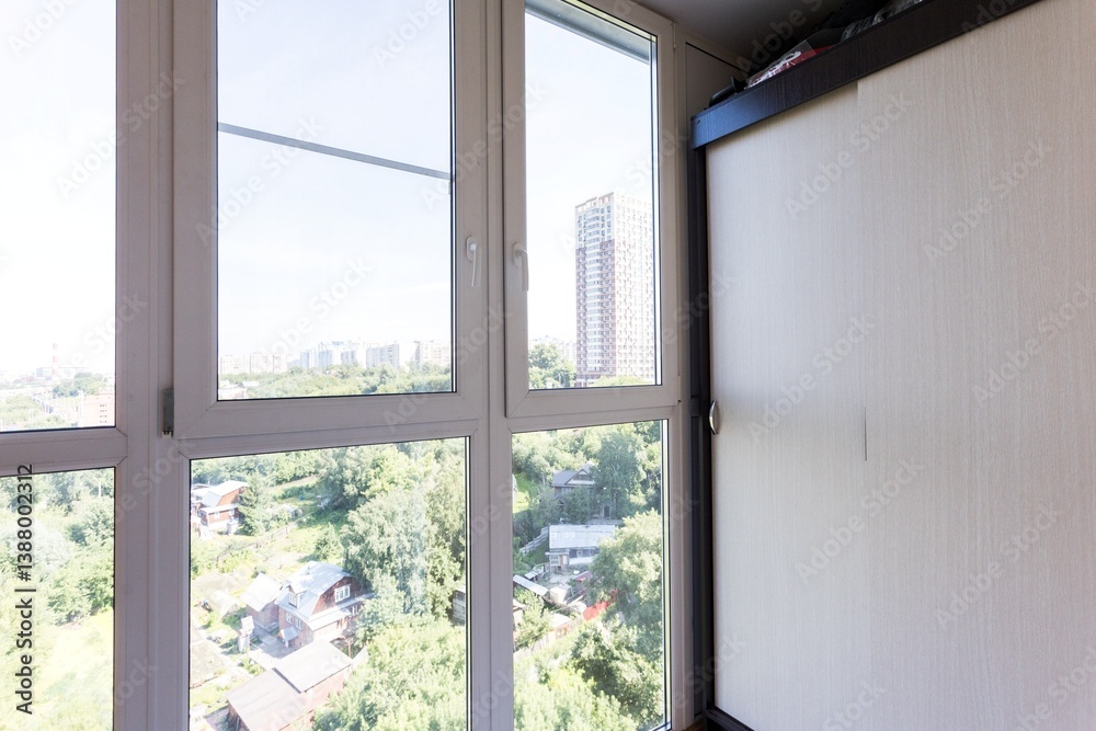 the balcony of an apartment on the upper floors of an apartment building the balcony of an apartment on the upper floors of an apartment building