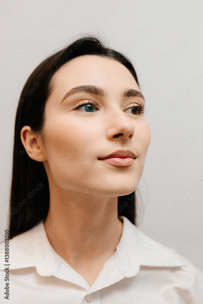 Heterochromia of eyes of girl in colored contact lenses on white background. Girl in blue contact lenses with heterochromia with different color of the eyes iris. Heterochromia of eyes of girl in colored contact lenses on white background. Girl in blue contact lenses with heterochromia with different color of the eyes iris.
