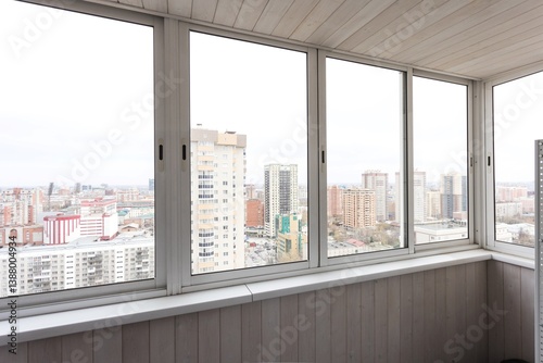 the balcony of an apartment on the upper floors of an apartment building