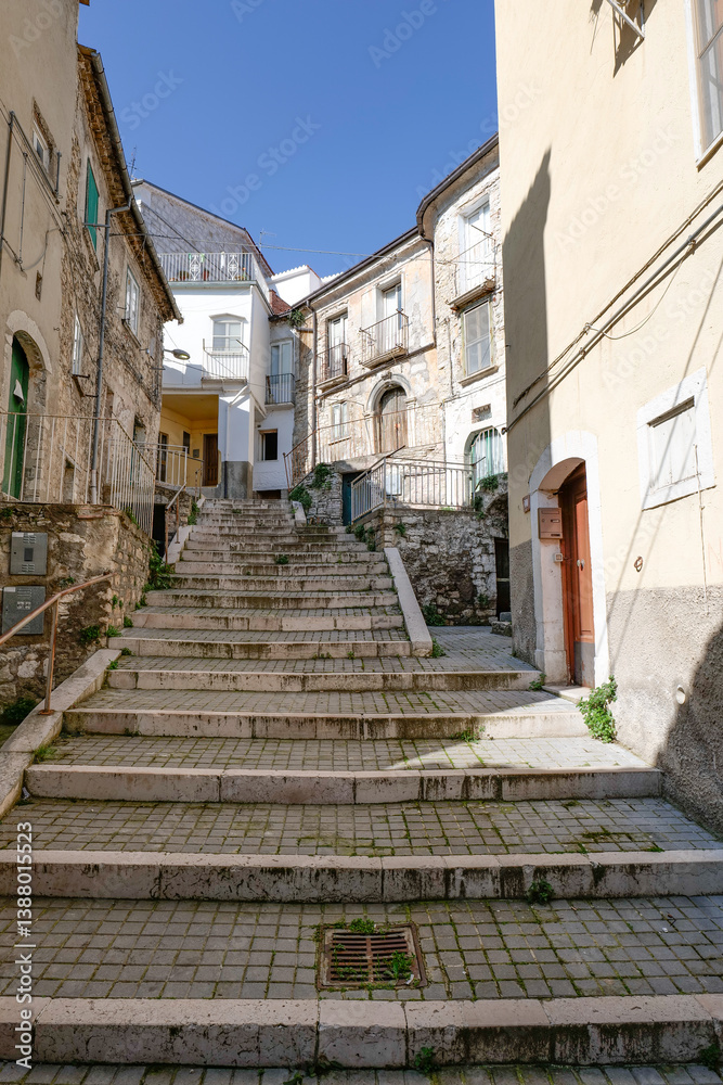 A narrow street among the old houses of Ripamolisani, a medieval village in Molise, Italy.