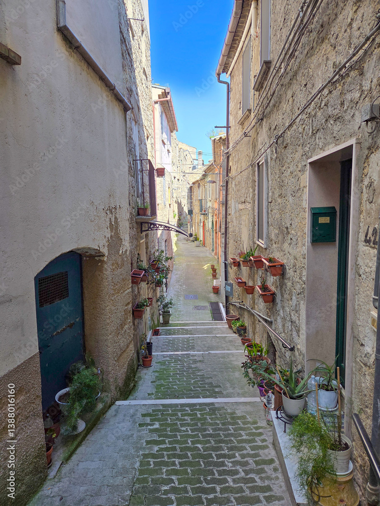 A narrow street among the old houses of Ripamolisani, a medieval village in Molise, Italy.