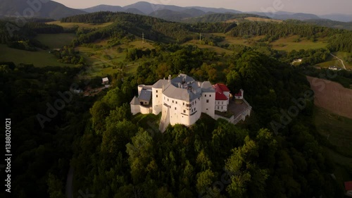 Monumental medieval castle at sunset, beautiful breathtaking drone shot. Lupčiansky hrad, Slovakia. 