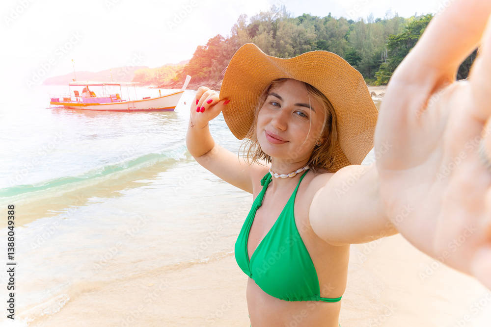 Travel selfie Young caucasian female relaxing on tropical beach in green bikini and hat